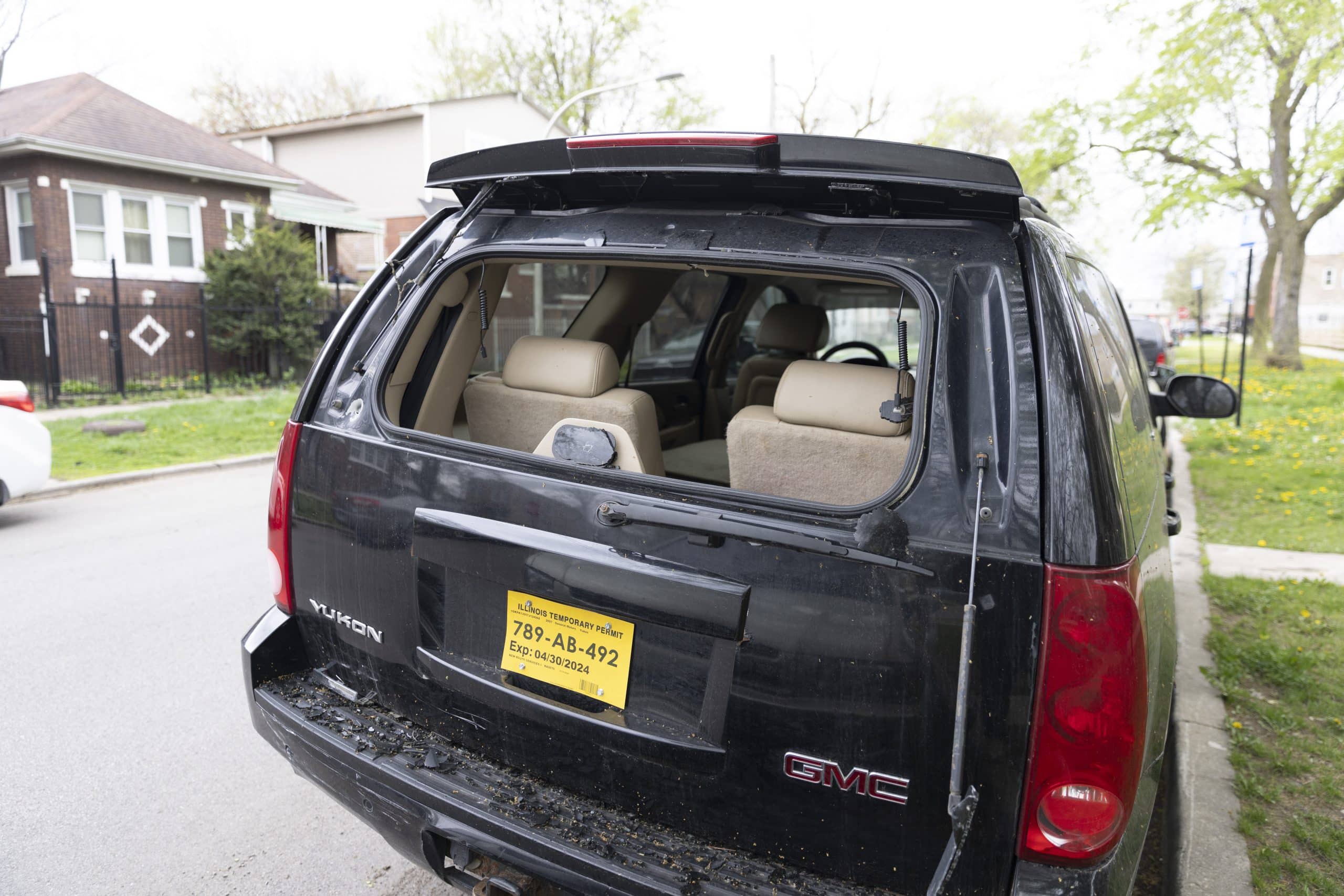 A black GMC Yukon with broken glass sits near the location where Dexter Reed was shoot on March 21, 2024.