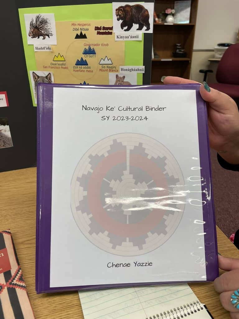 A purple notebook reads Navajo Ke Cultural Binder for a story about the five year COVID anniversary and indigneous communities.