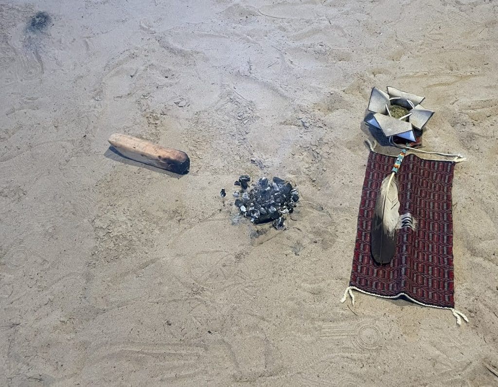 Various ritual items are laid out on the groud for a story about the five-year COVID anniversary and indigenous communities. 