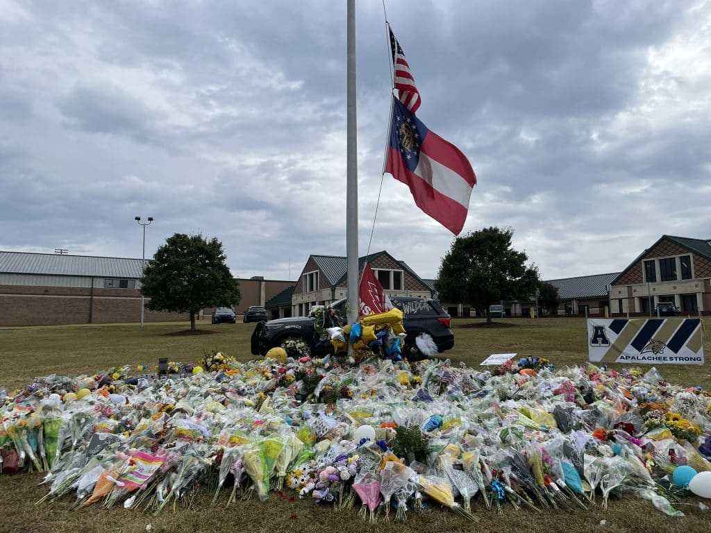 Scores of flower bouquets placed around the flagpole at Apalachee High School to honor two students and two teachers who were killed there by a 14-year-old student on Sept. 4.